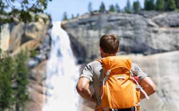20 Things To Do In Yosemite National Park Before You Die fun things to do in yosemite national park portrait of male adult back standing outdoor.