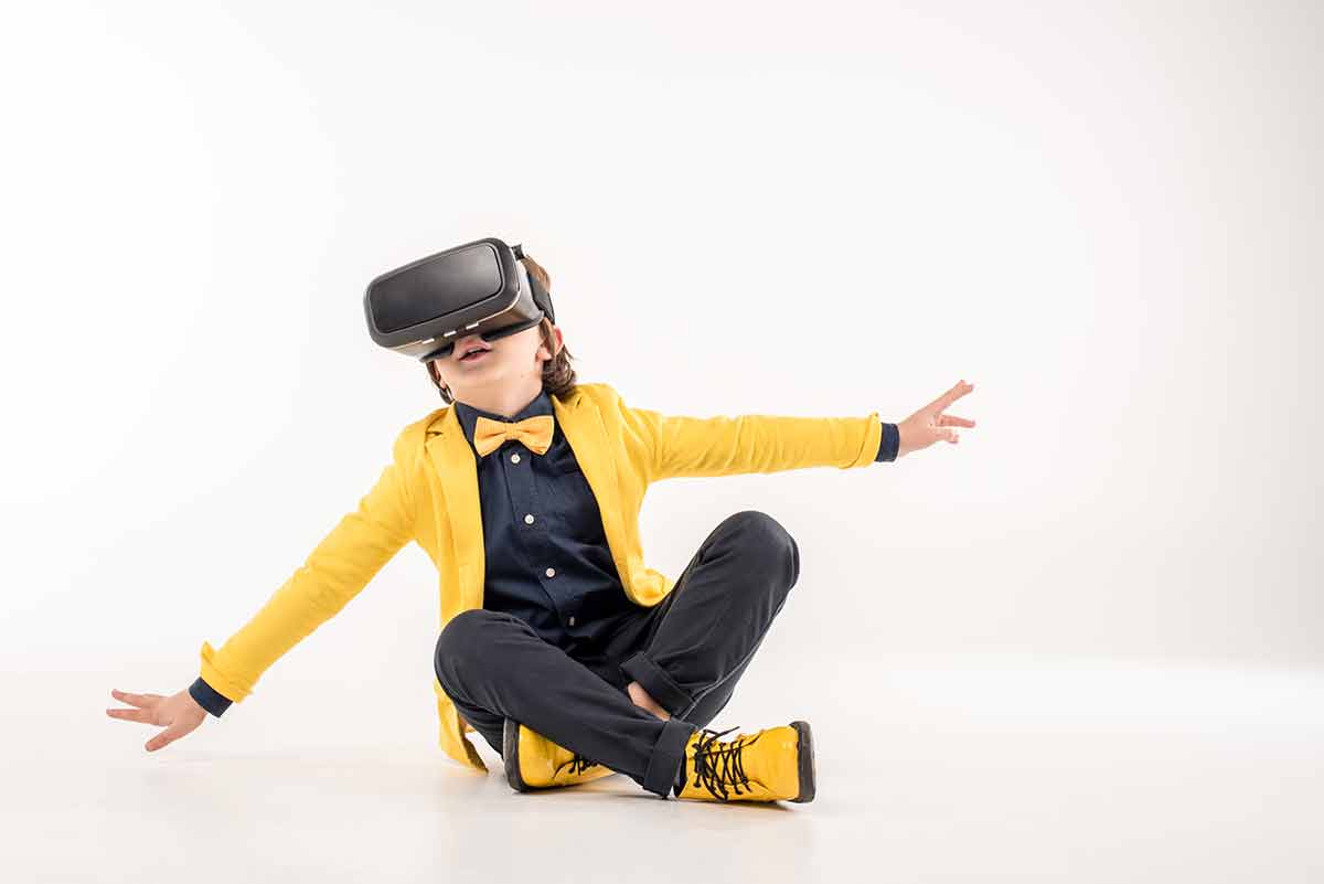 fun things to do santa ana kid in yellow sneakers and yellow blazer wearing virtual reality goggles