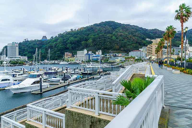 good day trips from tokyo atami promenade wtih green hill in background