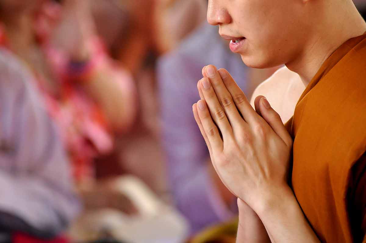 a Thai monk in prayer