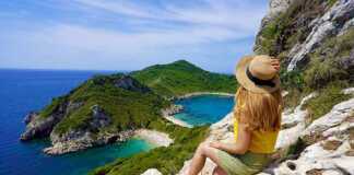 Female hiker girl enjoying natural landscape in Corfu Island, Greece.