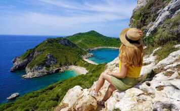 Female hiker girl enjoying natural landscape in Corfu Island, Greece.