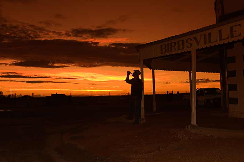 Outline of man drinking beer shows off the hats of Australian outback