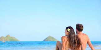 hawaii best beaches Hawaii vacation couple relaxing tanning on beach