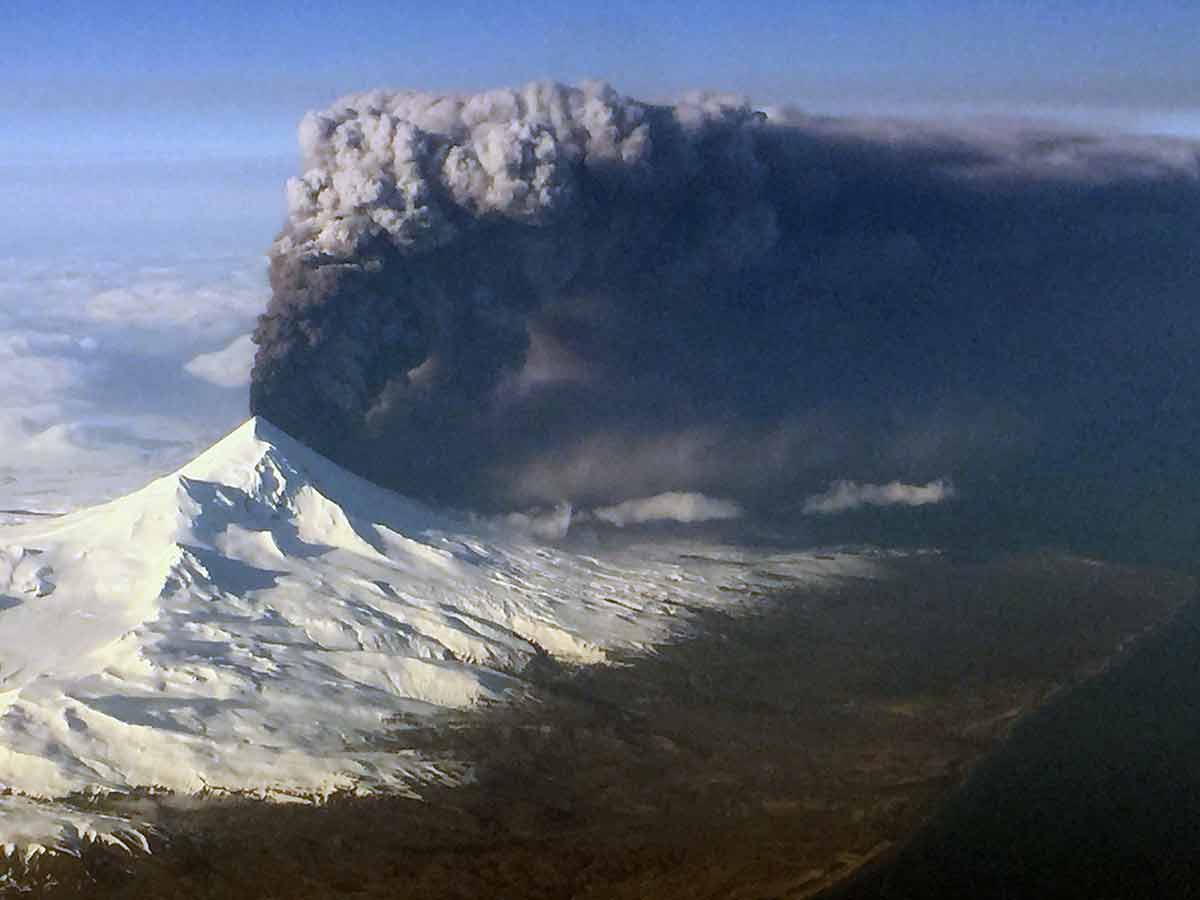 historical landmarks in alaska Pavlof Volcano with a thick cloud of ash