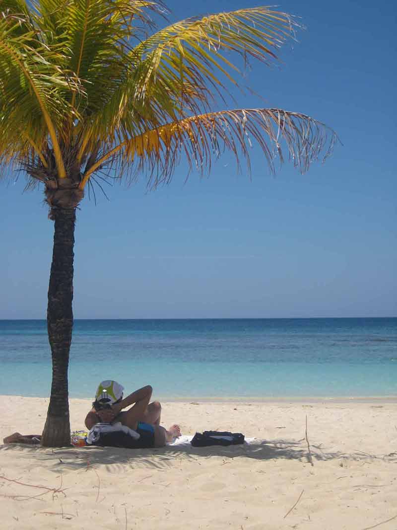 honduras pictures beaches woman under a palm tree.