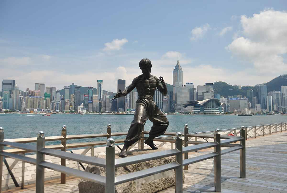 hong kong iconic landmarks Bruce Lee statue with skyscrapers in the backgound