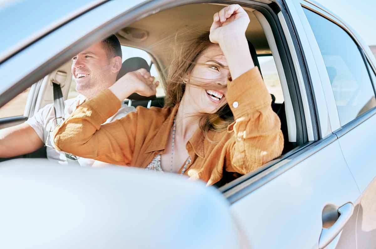 man with an excited woman with smile on a drive in the countryside