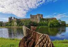 20 Welsh Cities And Towns That Will Make You Want To Visit Wales A Stunning View Of Pembroke Castle From Across The Moat