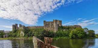 20 Welsh Cities And Towns That Will Make You Want To Visit Wales A Stunning View Of Pembroke Castle From Across The Moat