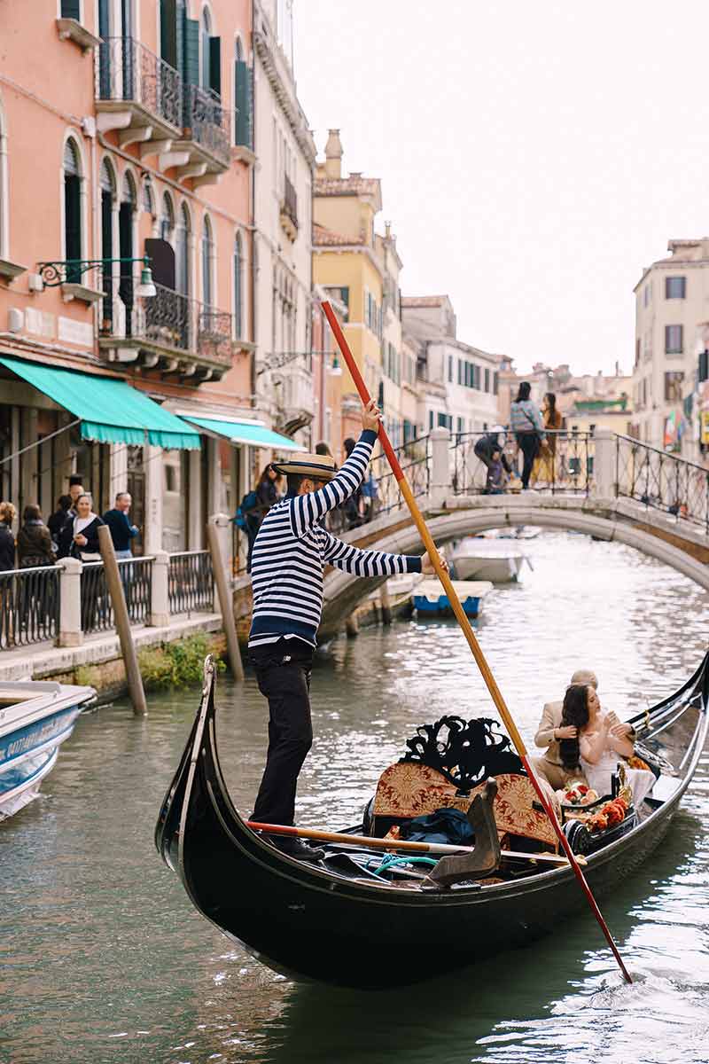 Bride And Groom In A Classic Wooden Gondola