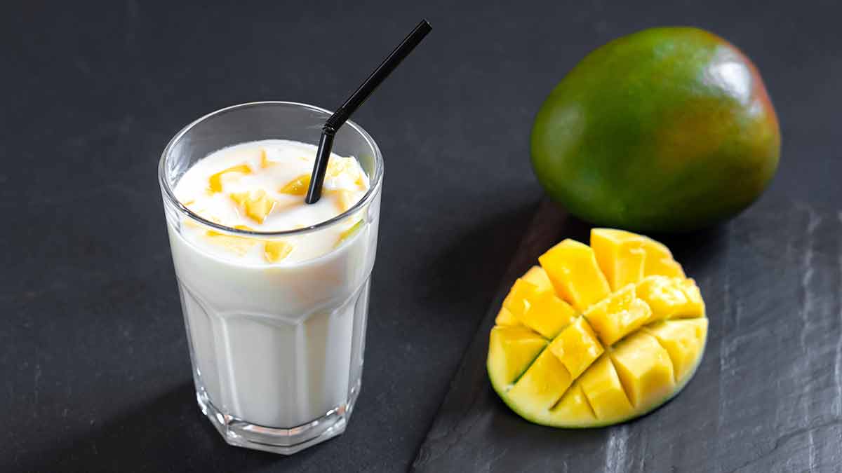 indian milk drinks Milk drink on black background with mango.