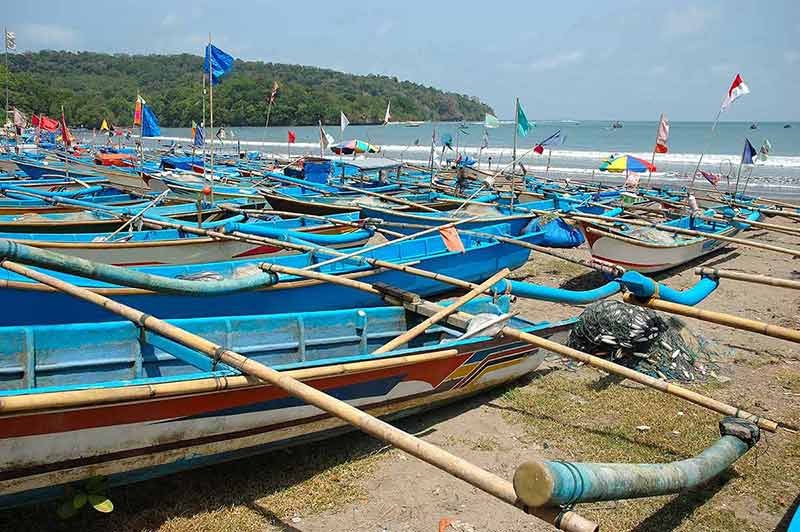 indonesia beaches fishing boats on the sand at Pangandaran beach