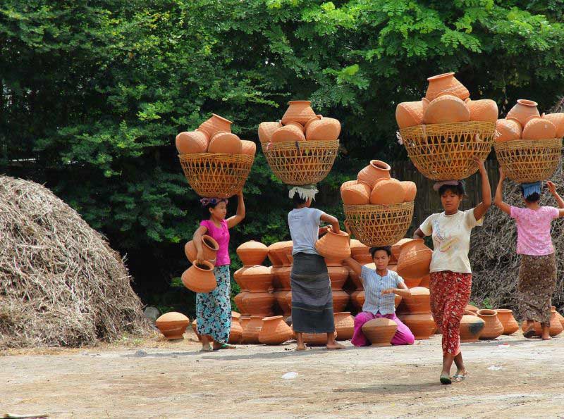women carrying pots on their heads in yandabo village