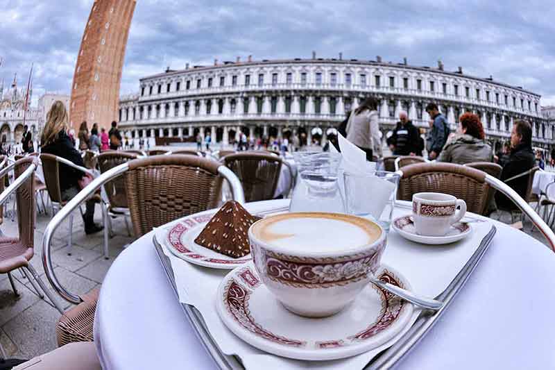 italian drinks non alcoholic cappuccino with historic building in the background