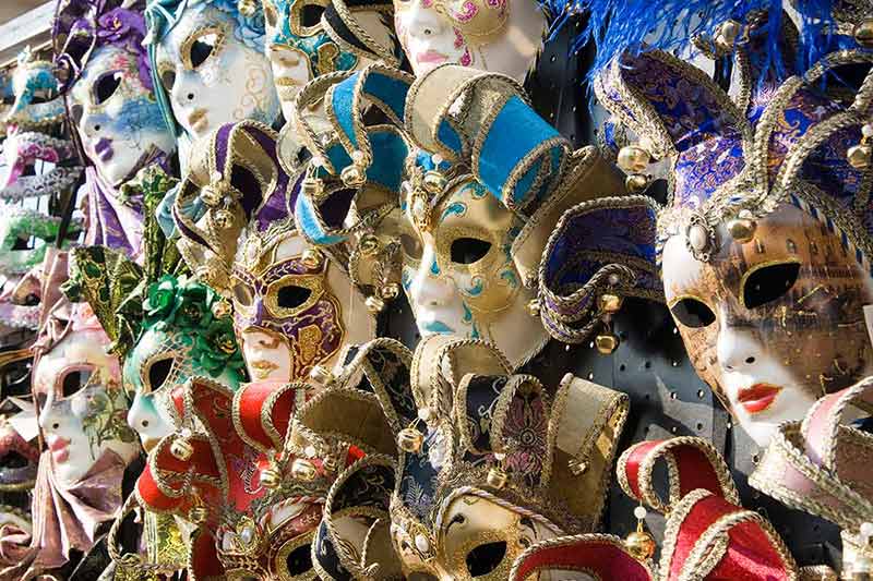 italy best time to visit colourful masks on a wall