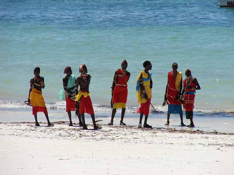 kenya beaches masai group of men wearing traditional colourful outfits