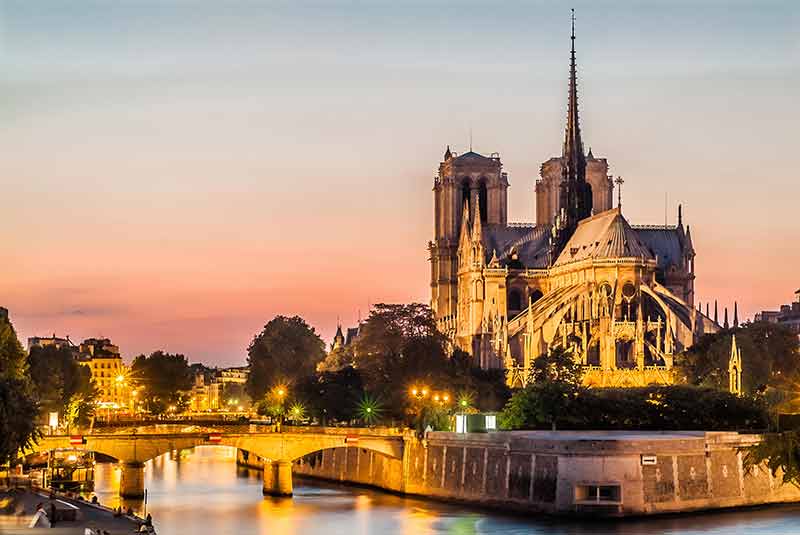 landmarks in paris france Notre-Dame de Paris at dusk