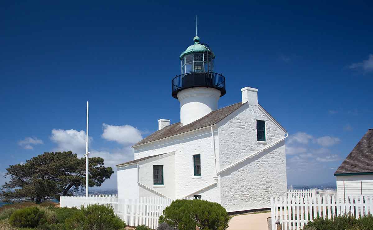 landmarks in san diego california old lighthouse on Point Loma with a bright blue sky framing the shot