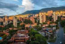 20 Colourful Colombian Cities And Towns That Will Make You Want To Book A Trip Medellin skyline with mountains in the background