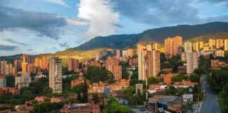 20 Colourful Colombian Cities And Towns That Will Make You Want To Book A Trip Medellin skyline with mountains in the background