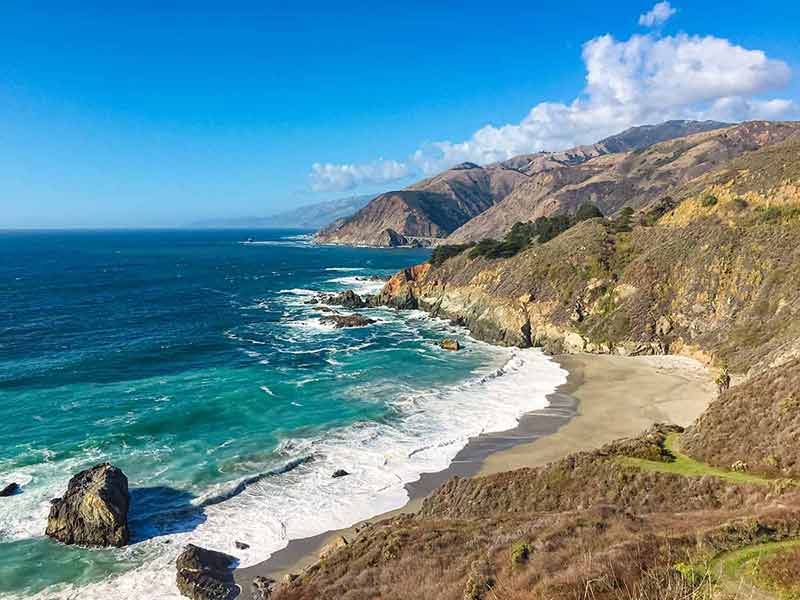 los angeles to san francisco road trip California big sur coast, ocean, mountains and blue sky with clouds