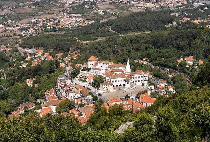 National Palace in the town of Sintra aerial view with green forest around it