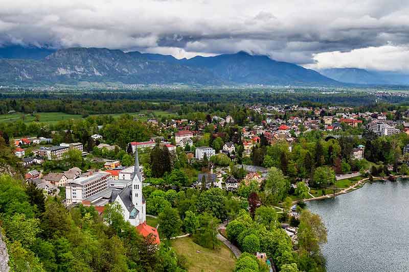 Aerial View Of Bled City With Alps Mountains