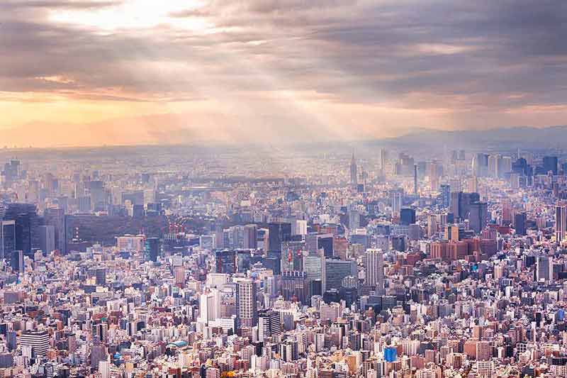 Aerial View Of Tokyo with sun's rays shining through the clouds