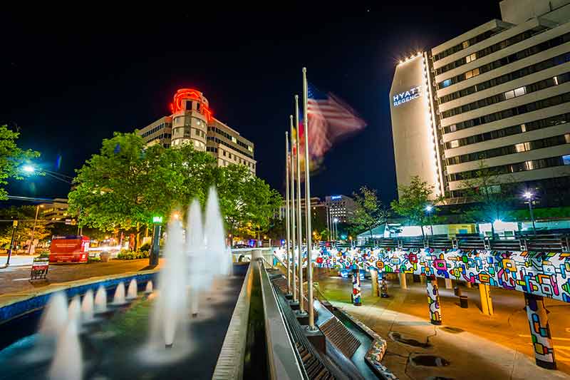 Bethesda fountains and city buildings at night