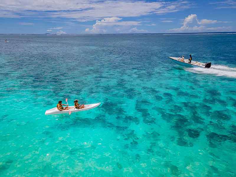 mauritius best beaches couple kayaking and speedboat
