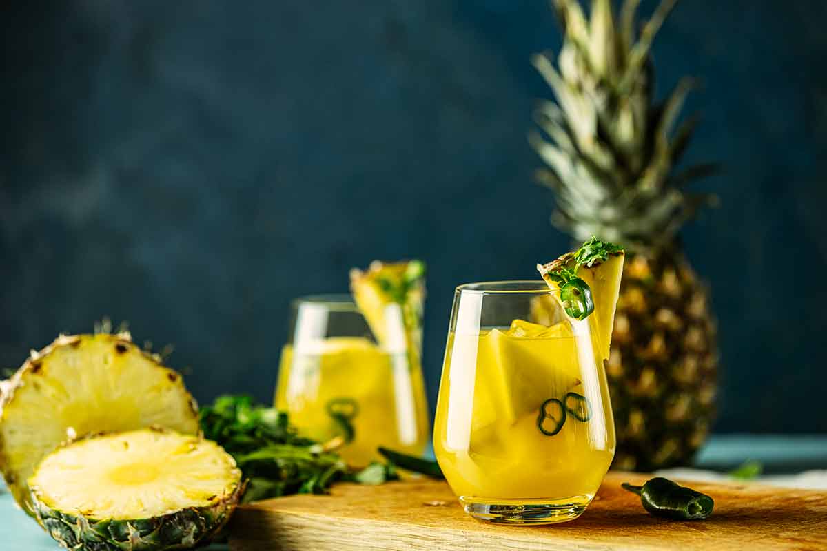 mexican pineapple drinks refreshing cocktail made with pineapple, cilantro, jalapeno and mexican distilled alcoholic beverage.