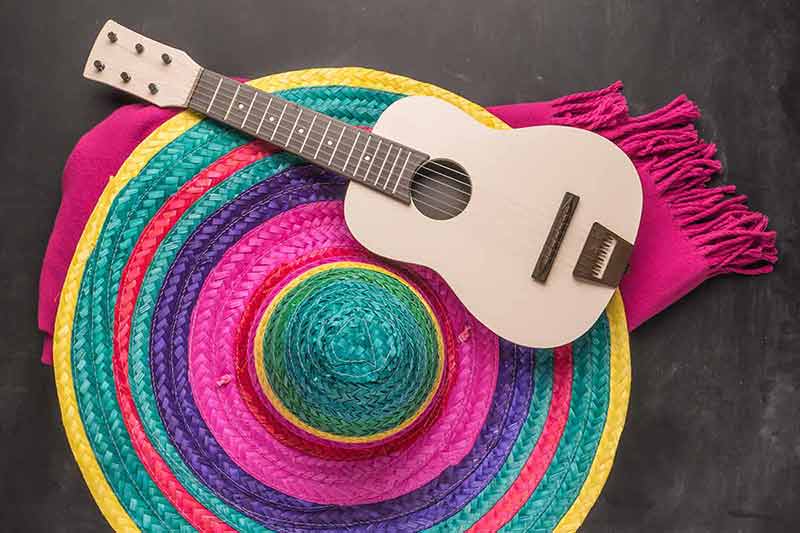 mexican wedding traditions Sombrero, guitar and blankets on rustic slate background