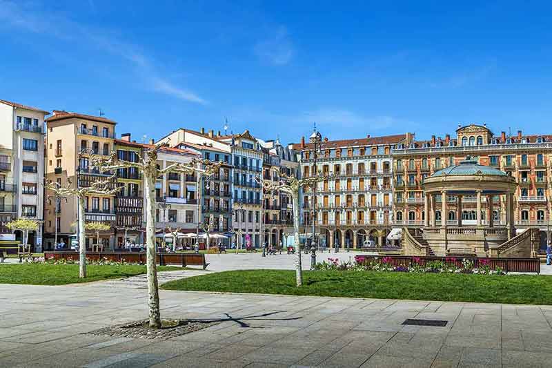 most beautiful cities in spain blue sky and colourful facade