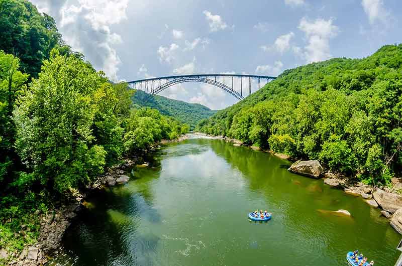 most scenic landmarks of west virginia bridge and boats with people in the foreground