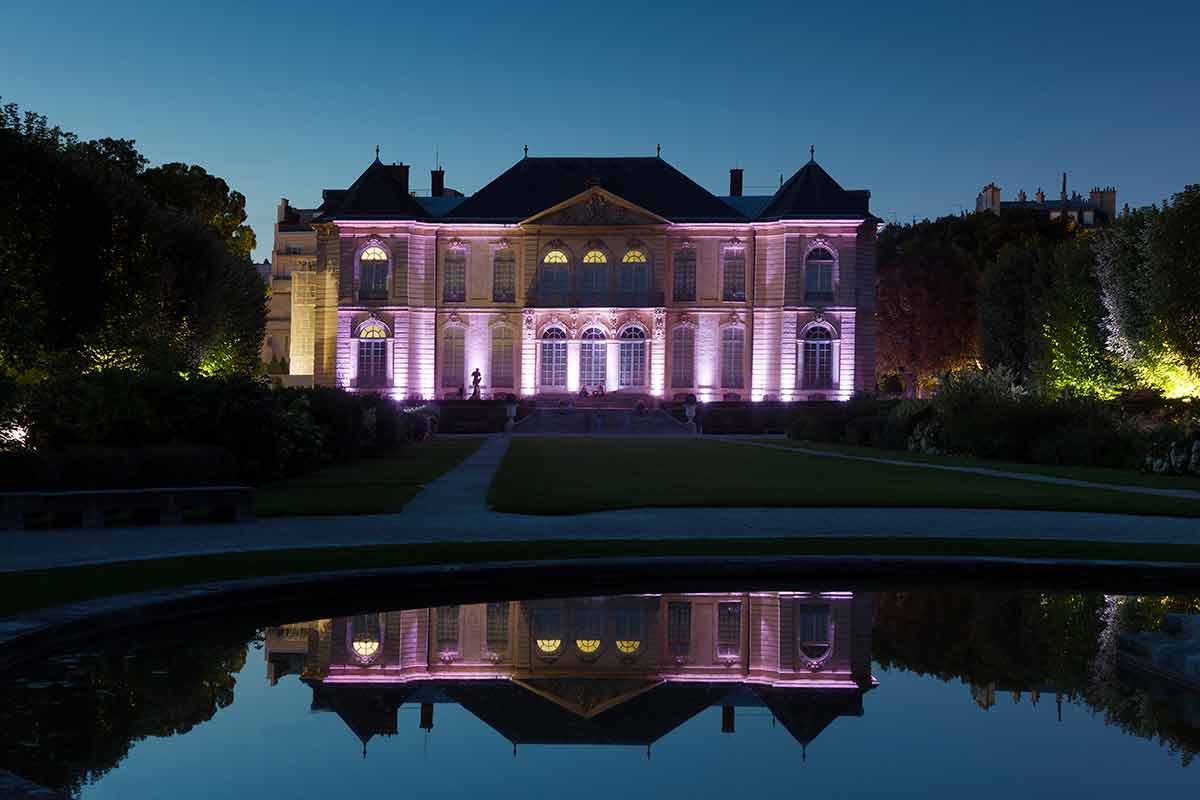 Rodin museum lit up at night and reflected in the water