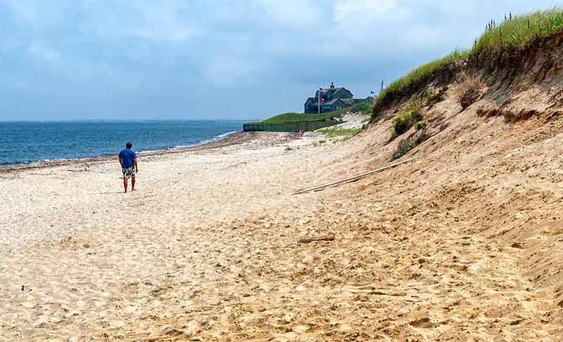 man walking on a Nantucket beach