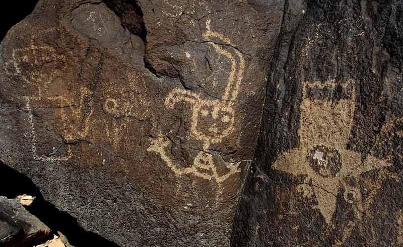 national parks and monuments in new mexico petroglyph of people on the rocks