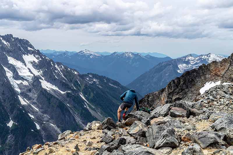 national parks in washington state north cascades man navigating a rocky trail