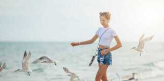 young girl and seagulls on neptune beach florida