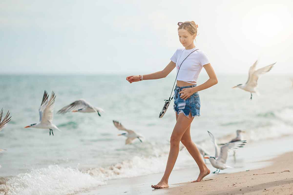young girl and seagulls on neptune beach florida