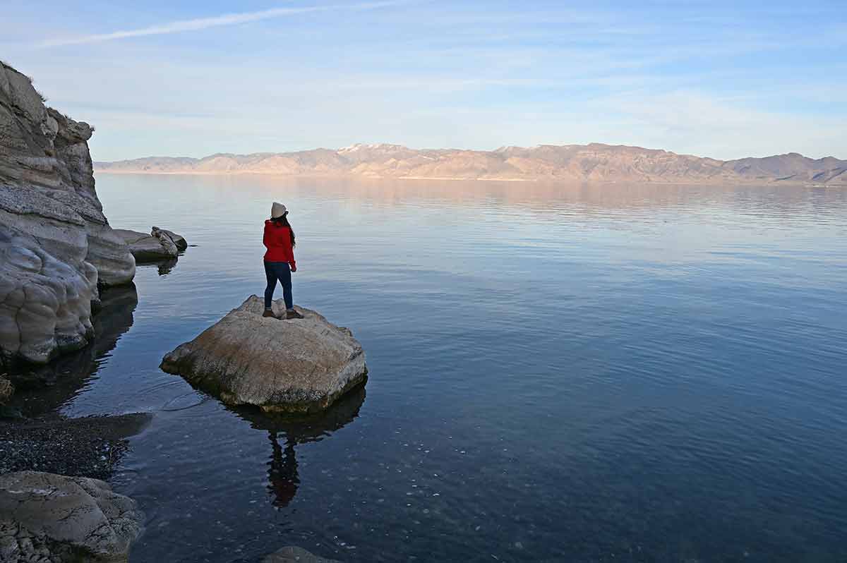 woman standing on a rock in nevada's famous landmark pyramid lake