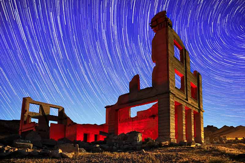 nevada historical sites rhyolite with star trails in the background