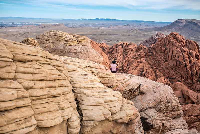 woman sitting on rock at nevada state landmarks red rock canyon