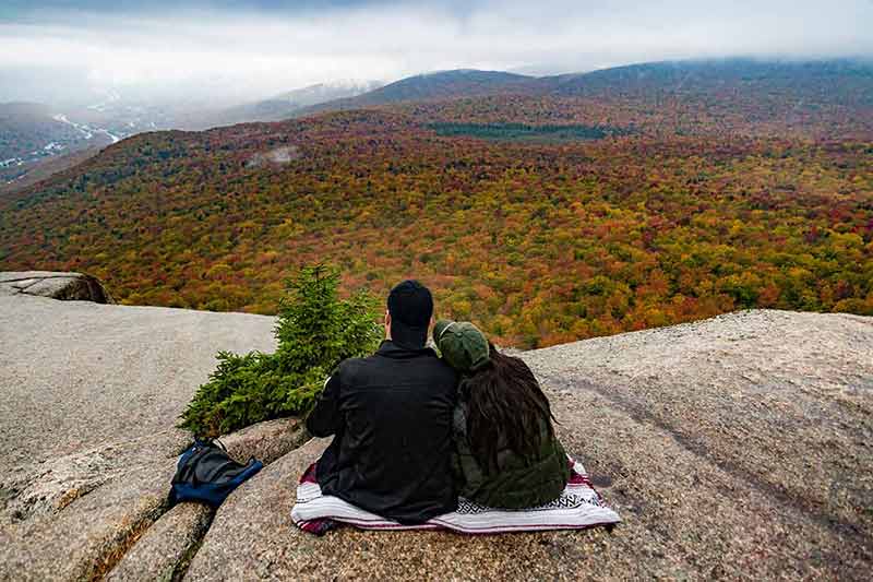 new hampshire national parks Two hikers watching fall foliage around Mount Washington
