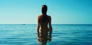 nicaragua beaches nude woman with dark wet hair standing in the water
