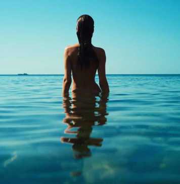 nicaragua beaches nude woman with dark wet hair standing in the water
