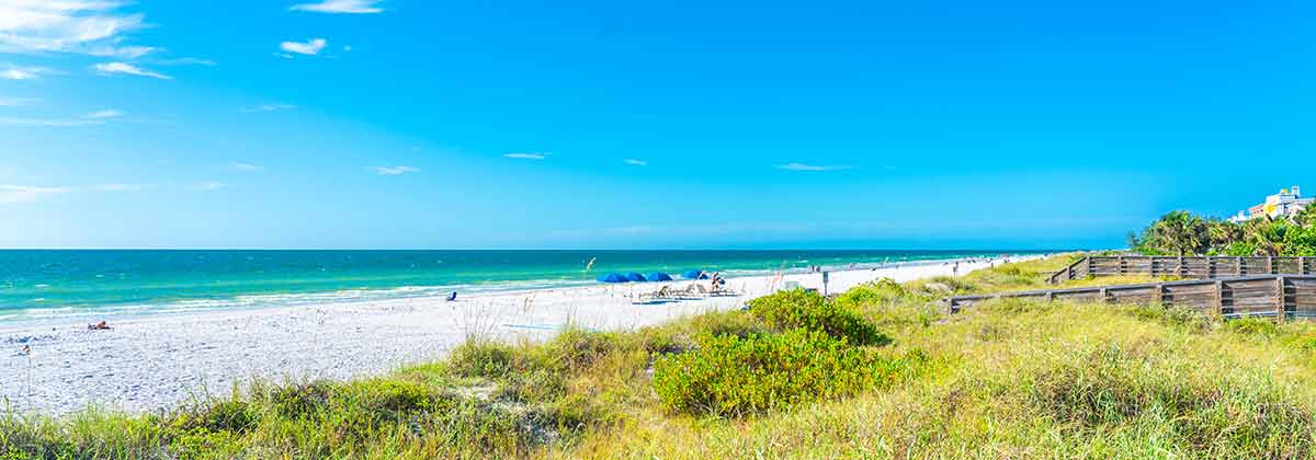 Indian Rocks Beach With Green Grass In Florida, USA