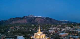 ogden utah aerial view with Mormon temple lit up and snowcapped mountains in the background.
