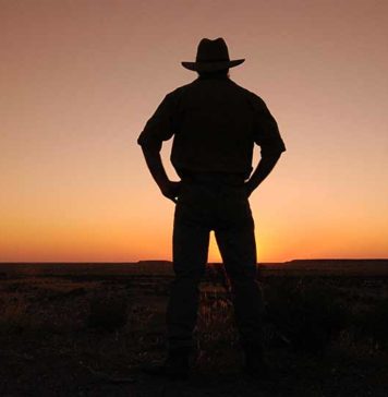 outback adventures at dusk with cowboy wearing a hat